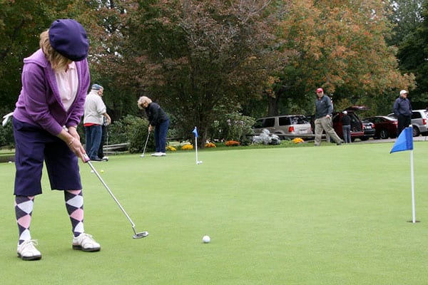 Golfer on practice putting green.