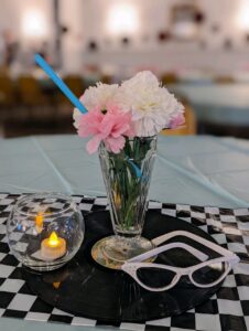 Featured image of flower vase on a checkered table cloth with a center piece